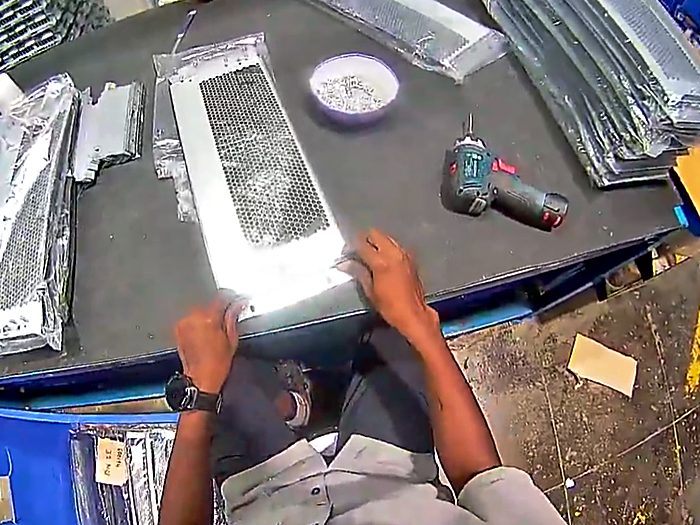 Metal parts laid out on a work surface during assembly.