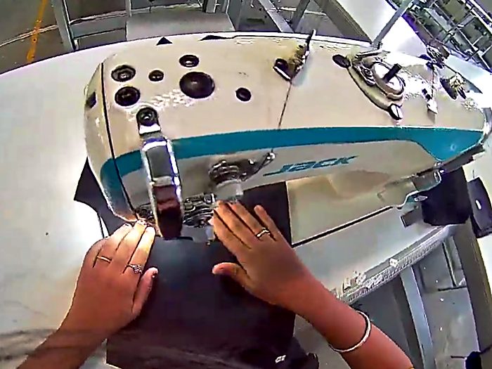 Guiding a cut panel through a stitching operation.
